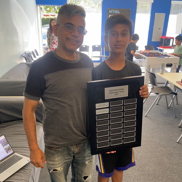 A student and parent with the Hackingtons Ambassador Award at the Dublin campus