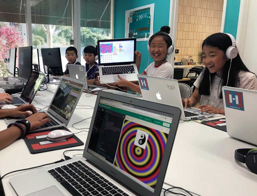 Smiling students coding side by side at Hackingtons Pleasant Hill