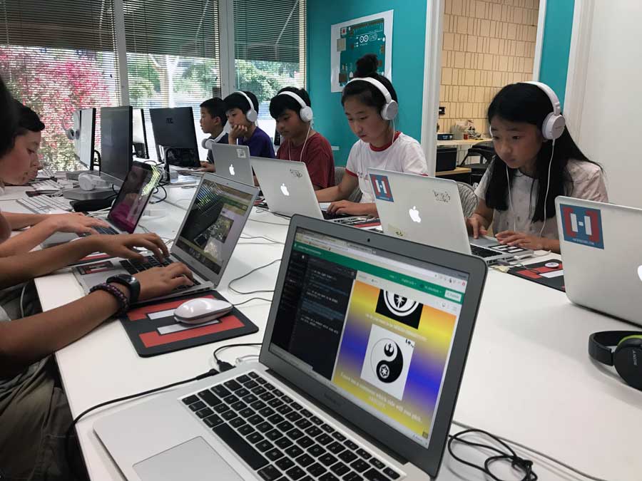 Students building projects on laptops at Hackingtons Pleasant Hill
