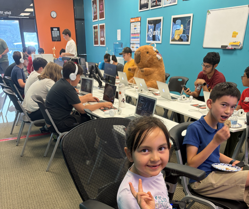 A young student giving a peace sign at the Hackingtons Rocklin anniversary celebration