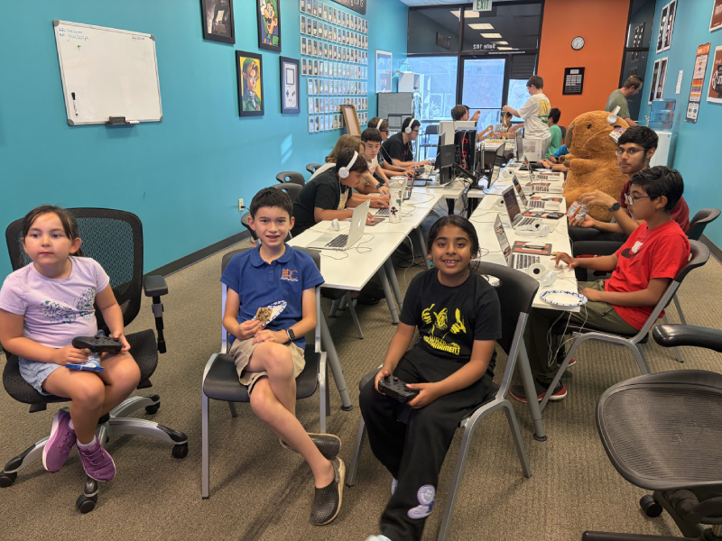 Students with game controllers at the Hackingtons Rocklin anniversary party
