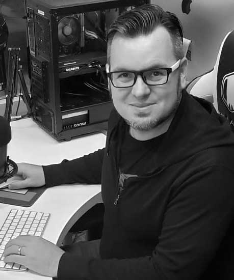 Matt Highland at his desk with a microphone.